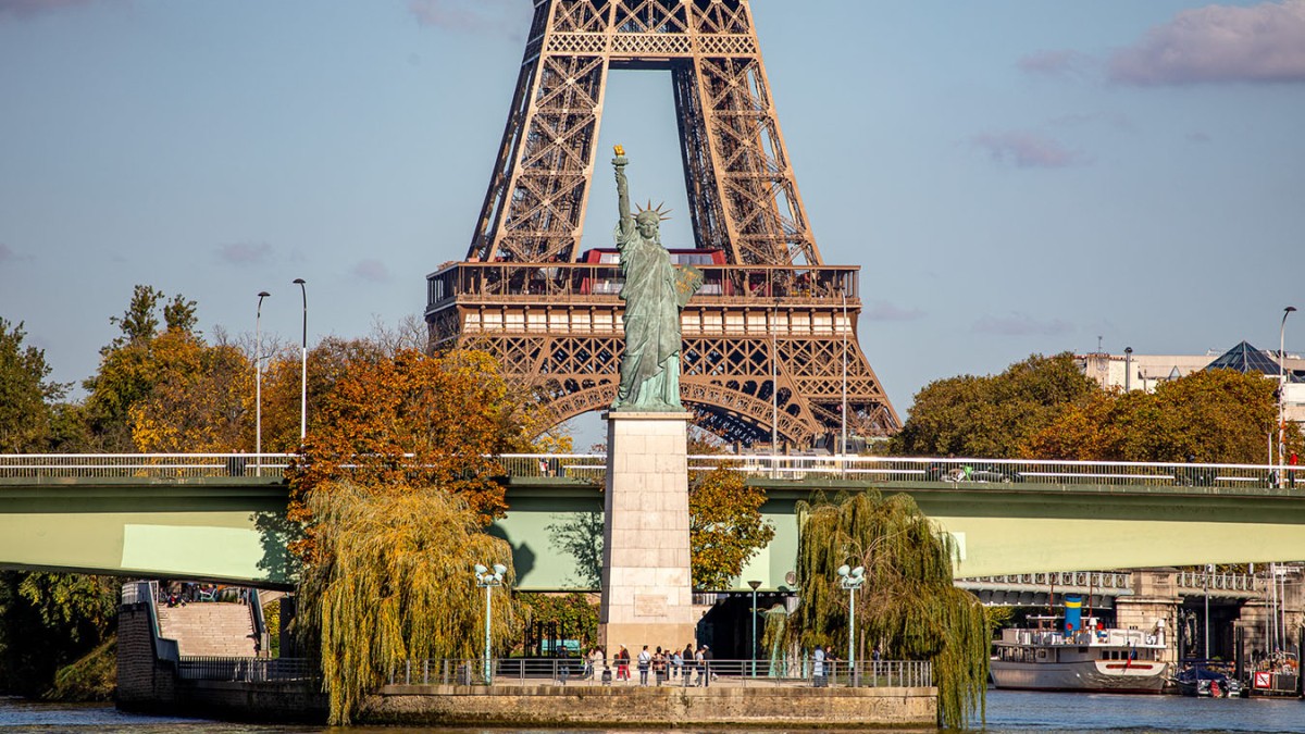 View of the Statue of Liberty in Paris with the Eiffel Tower in the background